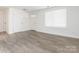 Bright living room featuring hardwood floors and modern design, with a window at 8432 Strider Dr, Charlotte, NC 28212