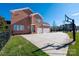 Spacious brick home with a basketball court and manicured lawn in the backyard at 9610 Pensive Ln, Waxhaw, NC 28173
