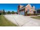 Large driveway and basketball court leading to a traditional brick home with a three-car garage at 9610 Pensive Ln, Waxhaw, NC 28173