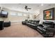 Home theater in the basement featuring a large leather couch and a TV at 9610 Pensive Ln, Waxhaw, NC 28173