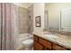 Well-lit bathroom with granite countertops, tiled shower and tub, and a framed mirror at 9610 Pensive Ln, Waxhaw, NC 28173