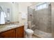 Bright bathroom featuring a glass enclosed shower, tiled walls and granite countertops at 9610 Pensive Ln, Waxhaw, NC 28173