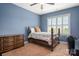 This bedroom offers a window with plantation shutters, a ceiling fan, and carpet floors at 9610 Pensive Ln, Waxhaw, NC 28173