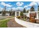 Beautifully landscaped entrance to 'The Gates at Ansley' with brick and white fencing at 9610 Pensive Ln, Waxhaw, NC 28173