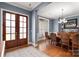 Elegant dining room boasts natural light, hardwood floors, and sophisticated lighting fixture at 9610 Pensive Ln, Waxhaw, NC 28173