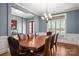 Spacious dining room with wainscoting, chandelier, and large windows for ample natural light at 9610 Pensive Ln, Waxhaw, NC 28173