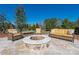 Inviting outdoor stone fire pit with cushioned seating on a large stone patio, perfect for entertaining at 9610 Pensive Ln, Waxhaw, NC 28173