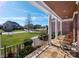 Charming front porch with stone flooring, white columns, and a rocking chair overlooking a green lawn at 9610 Pensive Ln, Waxhaw, NC 28173