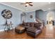 Cozy living room featuring hardwood floors, leather furniture and an ornate decoration at 9610 Pensive Ln, Waxhaw, NC 28173