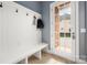 A mudroom featuring white wainscoting, a bench and hooks, and a door to the outside at 9610 Pensive Ln, Waxhaw, NC 28173