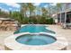 Backyard oasis with a pool, spa, and patio seating, ideal for outdoor entertaining and relaxation at 9610 Pensive Ln, Waxhaw, NC 28173