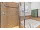 Bathroom featuring tiled shower, soaking tub, and neutral-toned decor at 103 Karlyn Ct, Mooresville, NC 28115