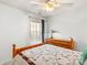 Bright bedroom featuring a decorative quilt, a side table, and a window with sheer curtains, creating a cozy and inviting atmosphere at 103 Karlyn Ct, Mooresville, NC 28115