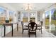 Inviting dining room with lots of natural light, stylish chandelier, and sliding glass door to yard at 103 Karlyn Ct, Mooresville, NC 28115