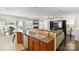 Open-concept kitchen seamlessly connects to the living and dining areas, featuring a breakfast bar and stainless steel dishwasher at 103 Karlyn Ct, Mooresville, NC 28115