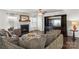Comfortable living room featuring a fireplace, large TV, dark hardwood floors, and plush seating at 103 Karlyn Ct, Mooresville, NC 28115