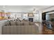 Open concept living room with hardwood floors, a fireplace, and plenty of natural light at 103 Karlyn Ct, Mooresville, NC 28115