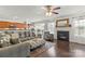 Bright living room with fireplace, ceiling fan, hardwood floors, and open concept leading to kitchen at 103 Karlyn Ct, Mooresville, NC 28115