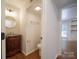 Half bath featuring vanity with sink, round mirror, and toilet in separate area at 105 Timber Ridge Rd, Belmont, NC 28012
