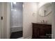Bathroom featuring marble shower, dark floors, vanity and gold fixtures at 105 Timber Ridge Rd, Belmont, NC 28012