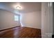 Bright bedroom featuring neutral walls, wood floors, and a window for natural light at 105 Timber Ridge Rd, Belmont, NC 28012