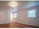 Bright bedroom with hardwood floors, two windows, and fresh white paint at 105 Timber Ridge Rd, Belmont, NC 28012