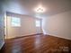 Light-filled bedroom with neutral walls, hardwood floors, and windows create a calming space at 105 Timber Ridge Rd, Belmont, NC 28012