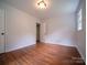 Bright bedroom featuring neutral walls, wood floors, and a window for natural light at 105 Timber Ridge Rd, Belmont, NC 28012