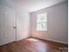 Cozy bedroom filled with natural light, showcasing hardwood floors and neutral paint at 105 Timber Ridge Rd, Belmont, NC 28012