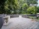 Wood deck overlooking the backyard, features wood railings, decorative planters and trees at 105 Timber Ridge Rd, Belmont, NC 28012
