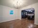 A modern dining room featuring hardwood floors and an open archway into the kitchen at 105 Timber Ridge Rd, Belmont, NC 28012