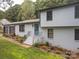 Two story home with manicured landscaping, a grey roof, dark accents and a vibrant blue front door at 105 Timber Ridge Rd, Belmont, NC 28012