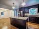 A modern kitchen featuring an island, granite counters, and stainless steel appliances at 105 Timber Ridge Rd, Belmont, NC 28012