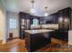 Modern kitchen featuring granite countertops, stainless steel appliances, and dark cabinets at 105 Timber Ridge Rd, Belmont, NC 28012