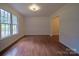 Bright living room with warm hardwood floors, natural light, and classic white trim at 105 Timber Ridge Rd, Belmont, NC 28012