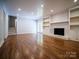 Bright living room boasts hardwood floors, fireplace and built-in shelves at 105 Timber Ridge Rd, Belmont, NC 28012