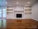 Living area features hardwood floors, fireplace and built-in shelves at 105 Timber Ridge Rd, Belmont, NC 28012