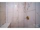 Tiled shower features marble walls, a built-in seat, and a brass shower head at 105 Timber Ridge Rd, Belmont, NC 28012