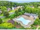 Aerial view of a community pool, clubhouse, and lush landscaping in a beautiful neighborhood at 1102 High Brook Dr, Waxhaw, NC 28173