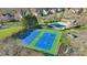 Aerial view of tennis courts, pool, and playground in a residential neighborhood at 1102 High Brook Dr, Waxhaw, NC 28173