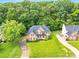 Sprawling aerial view of a brick home with a large yard and surrounded by mature trees at 1102 High Brook Dr, Waxhaw, NC 28173