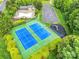 Aerial view of community amenities including tennis courts, pool, clubhouse, parking, playground, and lush landscaping at 1102 High Brook Dr, Waxhaw, NC 28173