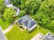 Aerial view of a home with a gray roof, lush landscaping, and an inviting driveway at 1102 High Brook Dr, Waxhaw, NC 28173