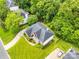 Lovely aerial view of house with well-manicured lawn and driveway surrounded by mature trees at 1102 High Brook Dr, Waxhaw, NC 28173