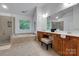 Bright bathroom features a tub, seamless shower, and double vanity, designed for relaxation and convenience at 1102 High Brook Dr, Waxhaw, NC 28173