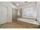 This bathroom offers a glass shower and a soaking tub with tile surround at 1102 High Brook Dr, Waxhaw, NC 28173