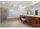 The primary bathroom features a glass shower, tub, and a vanity with dual sinks at 1102 High Brook Dr, Waxhaw, NC 28173