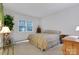 A bedroom with white walls, neutral carpet, a window, and wooden furniture at 1102 High Brook Dr, Waxhaw, NC 28173