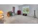 Bright bedroom featuring a cozy sitting area and a view of the outdoors through a large window at 1102 High Brook Dr, Waxhaw, NC 28173