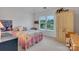 A bedroom with white walls, neutral carpet, a window, and decor at 1102 High Brook Dr, Waxhaw, NC 28173